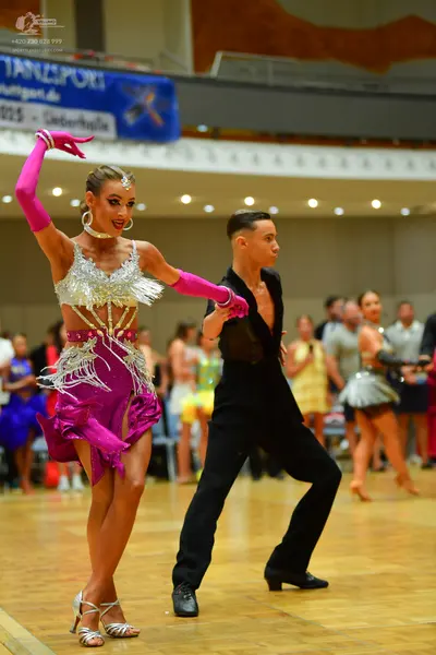 Dancesport competitor: Male dancer: black latin dance shirt and black trousers with black dance shoes