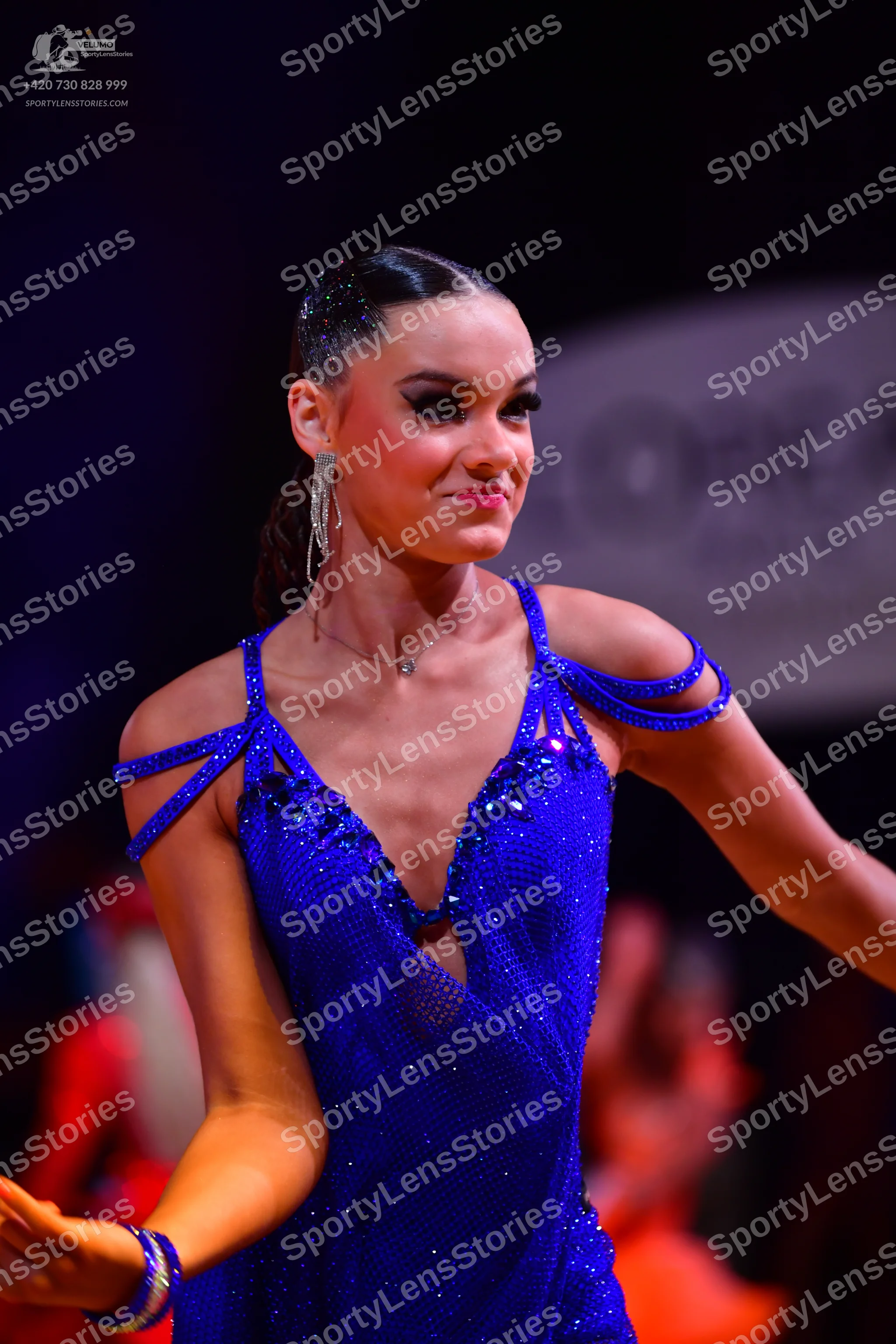 Dancesport competitor: Female dancer: royal blue latin dress made of sequined fabric with thin straps a