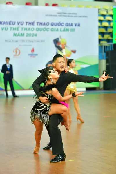 Dancesport competitor: Male:** Black tail suit with silver sequin lapels and matching silver sequins al