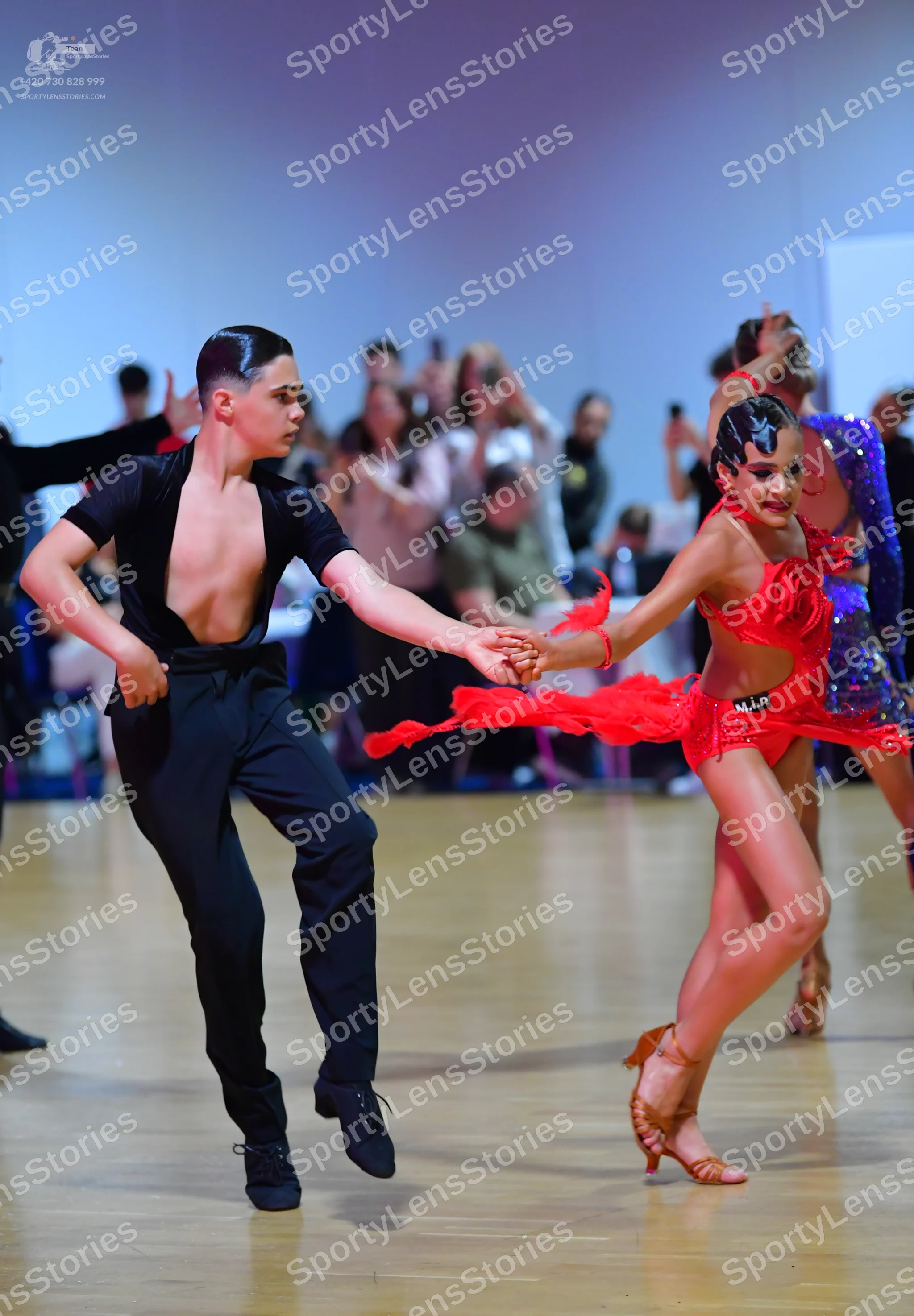 Dancesport competitor: Male dancer: black short-sleeved shirt with a deep V-neck and black trousers