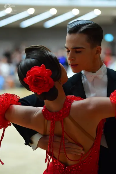 Dancesport competitor: Male dancer: black suit with a white shirt and white bowtie