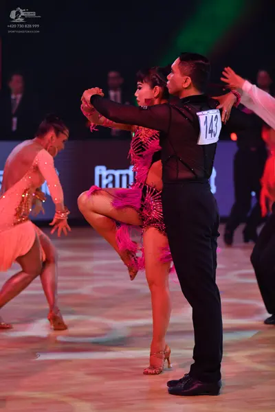 Dancesport competitor: Male dancer: black long-sleeved top with mesh panels and black trousers