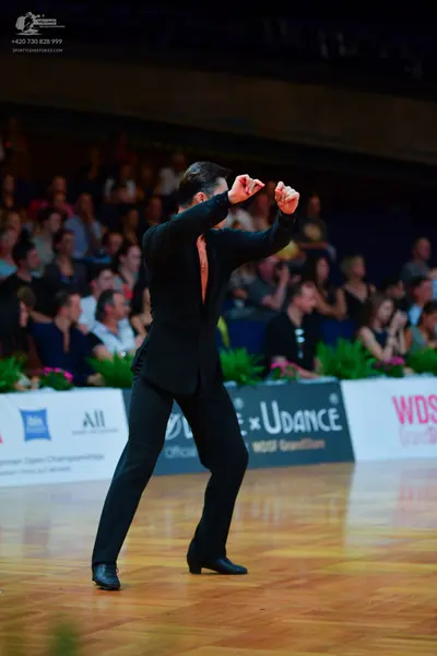 Dancesport competitor: Male dancer: black suit