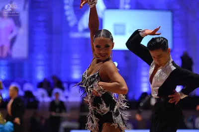 Dancesport competitor: Female dancer: black Latin dance dress with sequins and fringe