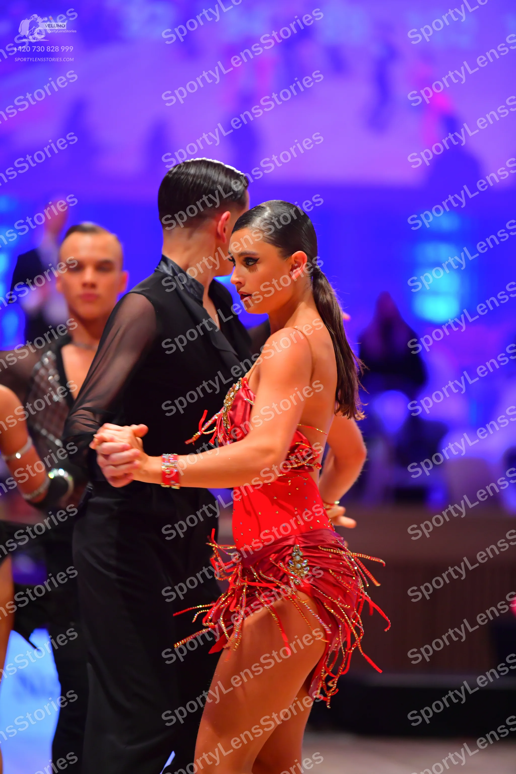 Dancesport competitor: Male dancer: black shirt with sheer mesh sleeves and black trousers