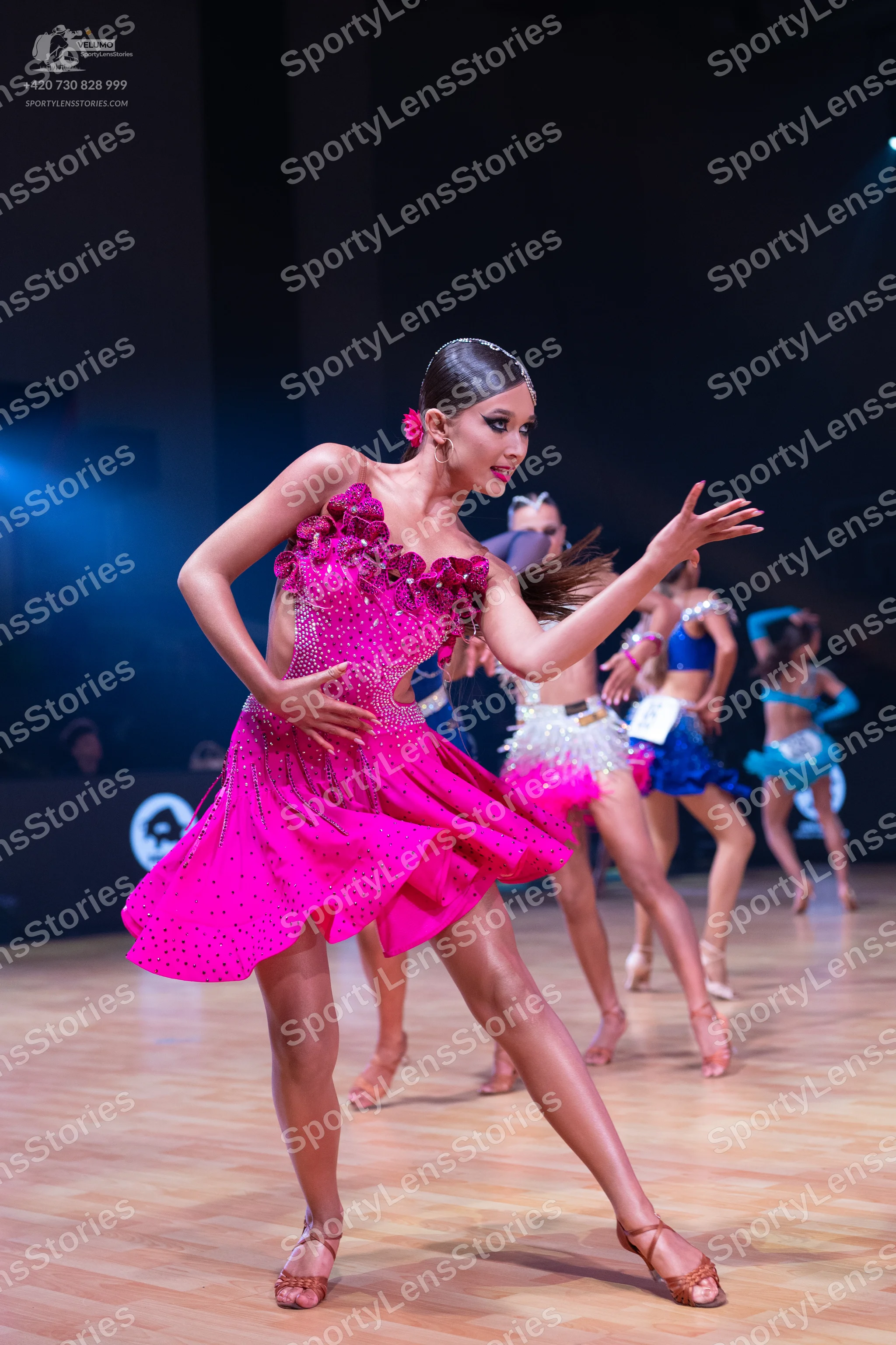 Dancesport competitor: Female dancer 1: pink sequin latin dress with an asymmetrical, ruffled design