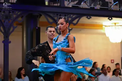 Dancesport competitor: Male dancer: black long-sleeved shirt with a patterned, lace-like fabric