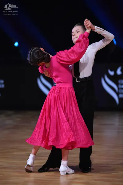 Dancesport competitor: Male dancer: white long-sleeved shirt and black trousers