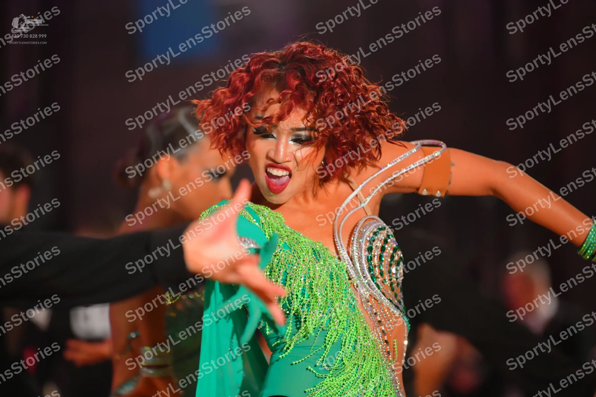 Dancesport competitor: Female dancer: bright green Latin dance dress with heavy sequin and crystal embe