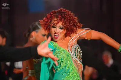 Dancesport competitor: Female dancer: bright green Latin dance dress with heavy sequin and crystal embe