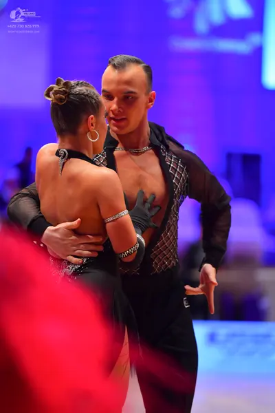 Dancesport competitor: Male dancer: black sheer long-sleeved shirt with a sequined mesh pattern on the 