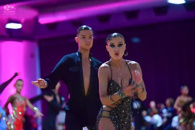 Dancesport competitor: Male dancer: black long-sleeved top with a deep V-neckline