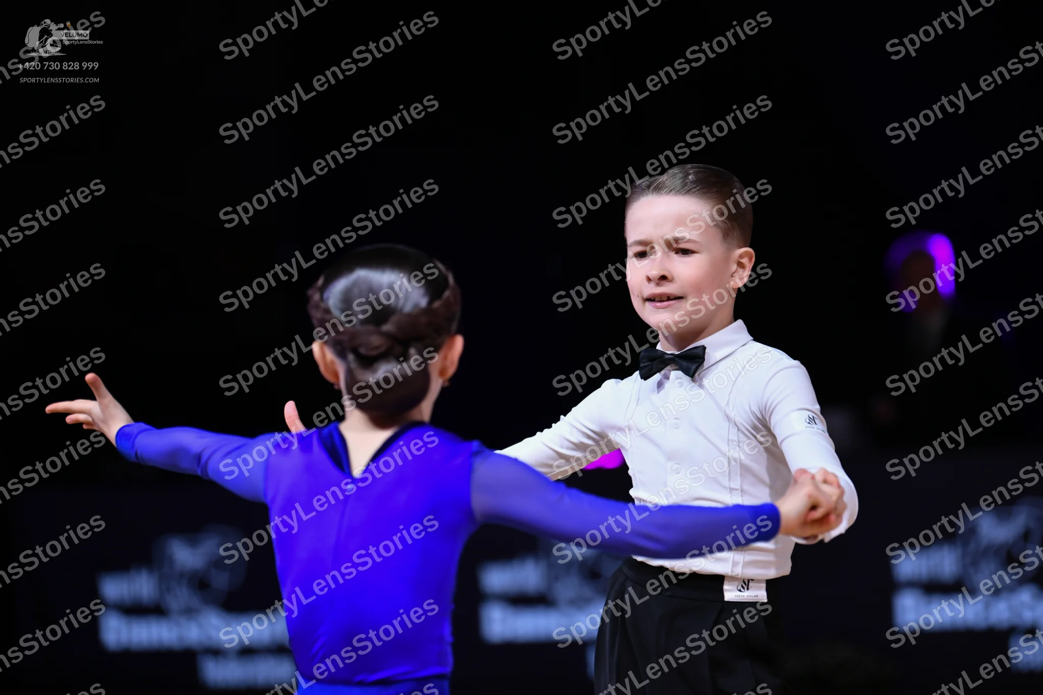 Dancesport competitor: Male dancer: white long-sleeved shirt, black trousers, and a black bow tie