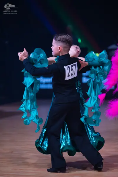 Dancesport competitor: Male dancer: black long-sleeved top and black trousers