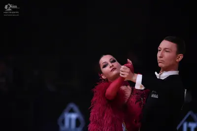 Dancesport competitor: Male dancer: black long-sleeved shirt with a white collar