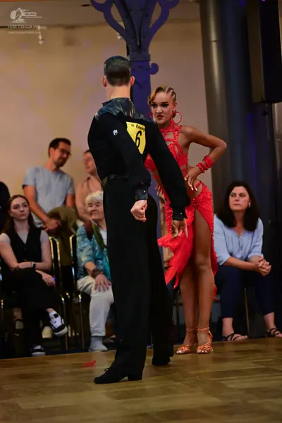 Dancesport competitor: Male dancer: black long-sleeved Latin dance shirt and trousers