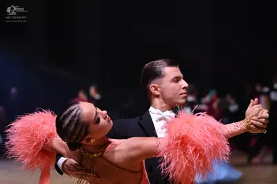Dancesport competitor: Male dancer: black suit with a white shirt and white bowtie