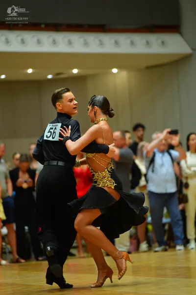 Dancesport competitor: Male dancer: black long-sleeved shirt and black trousers