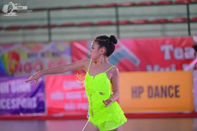 Dancesport competitor: ** Female: Bright neon green (almost highlighter) body suit
