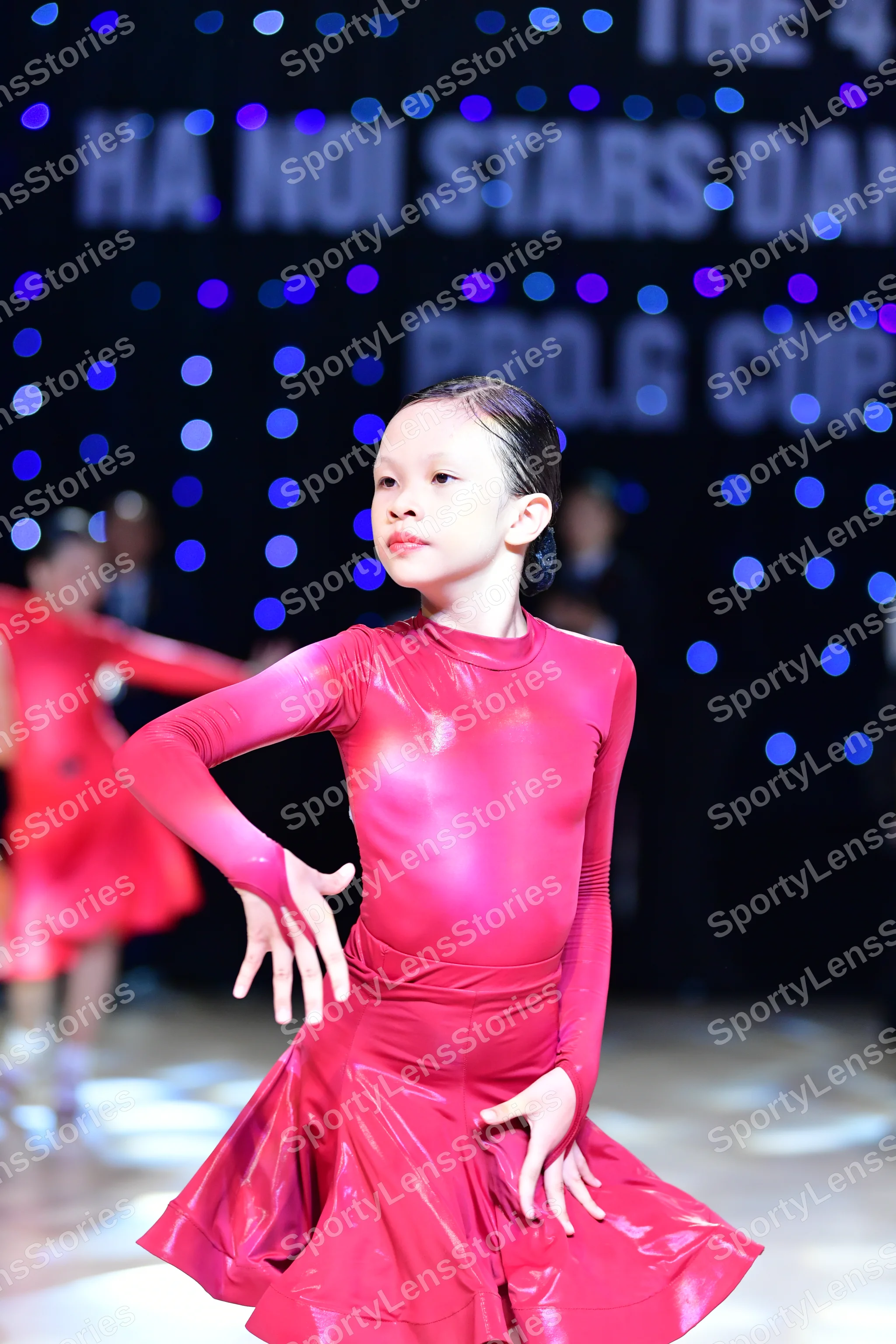 Dancesport competitor: ** Both dancers are wearing a single-color, form-fitting red dress