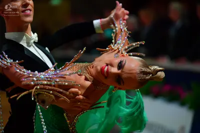 Dancesport competitor: Male dancer: black suit with a white shirt and white bow tie