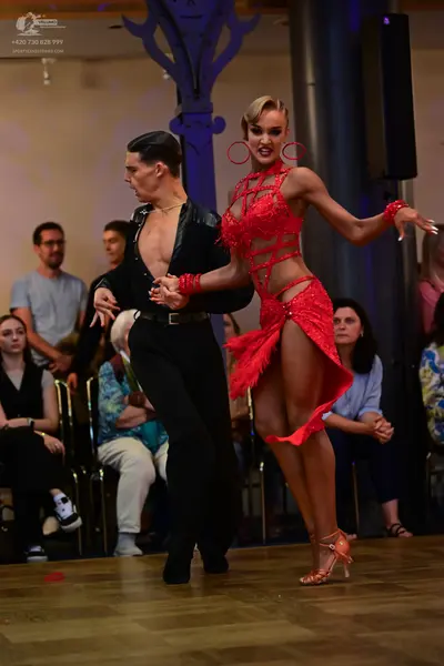 Dancesport competitor: Male dancer: black long-sleeved shirt and black trousers