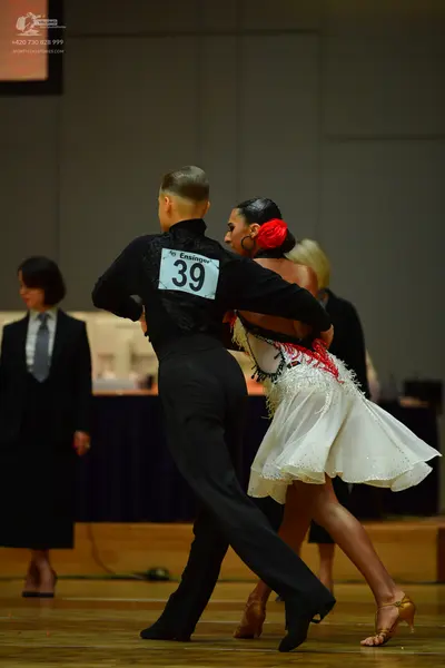 Dancesport competitor: Male dancer: black long-sleeved shirt and black trousers