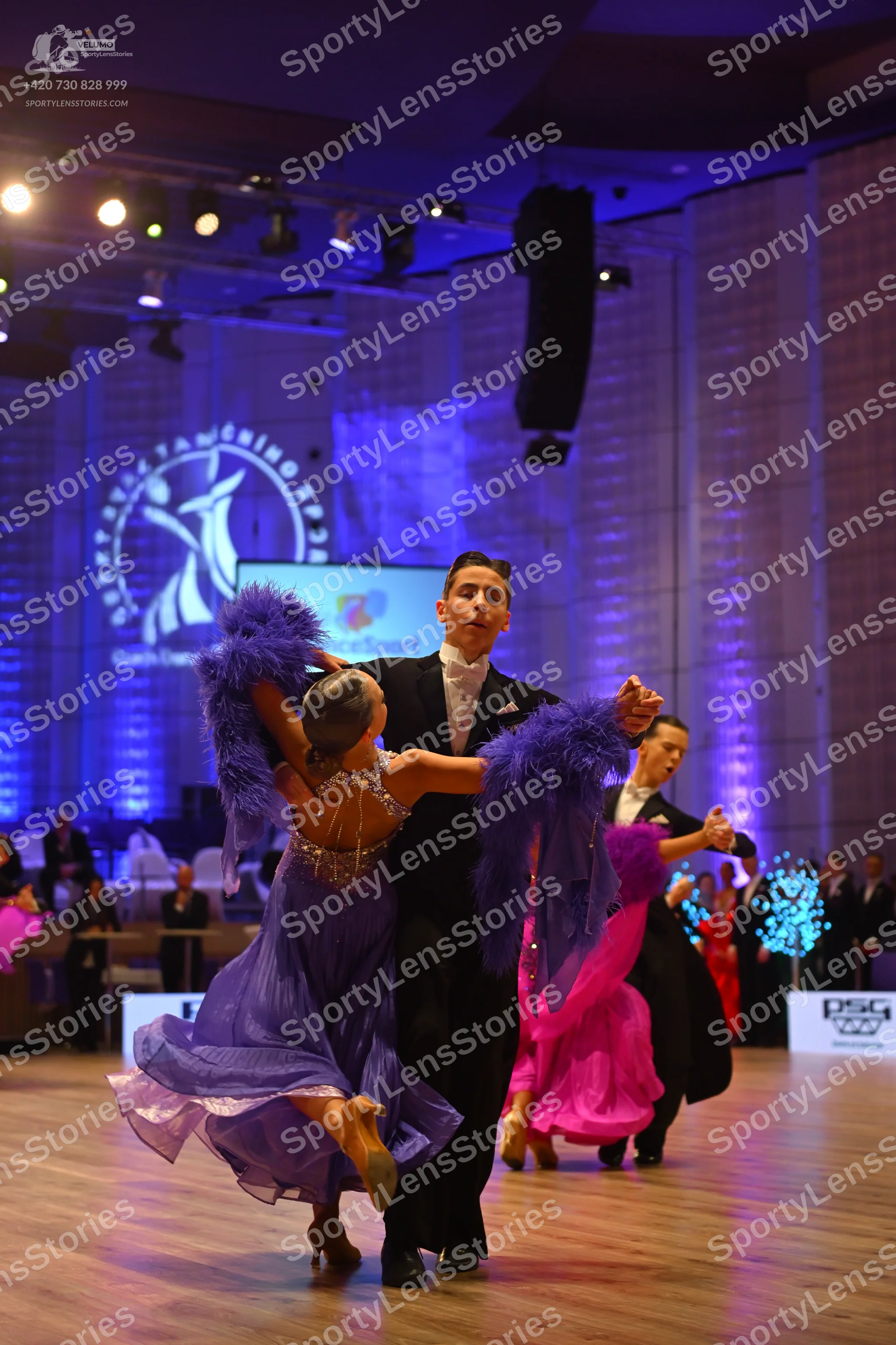 Dancesport competitor: Female dancer 1: purple latin dress with a sparkly, beaded bodice and flowing sk