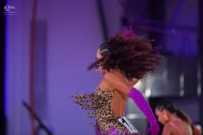 Dancesport competitor: Female dancer 1: leopard print Latin dress with fringe and a long purple sequine