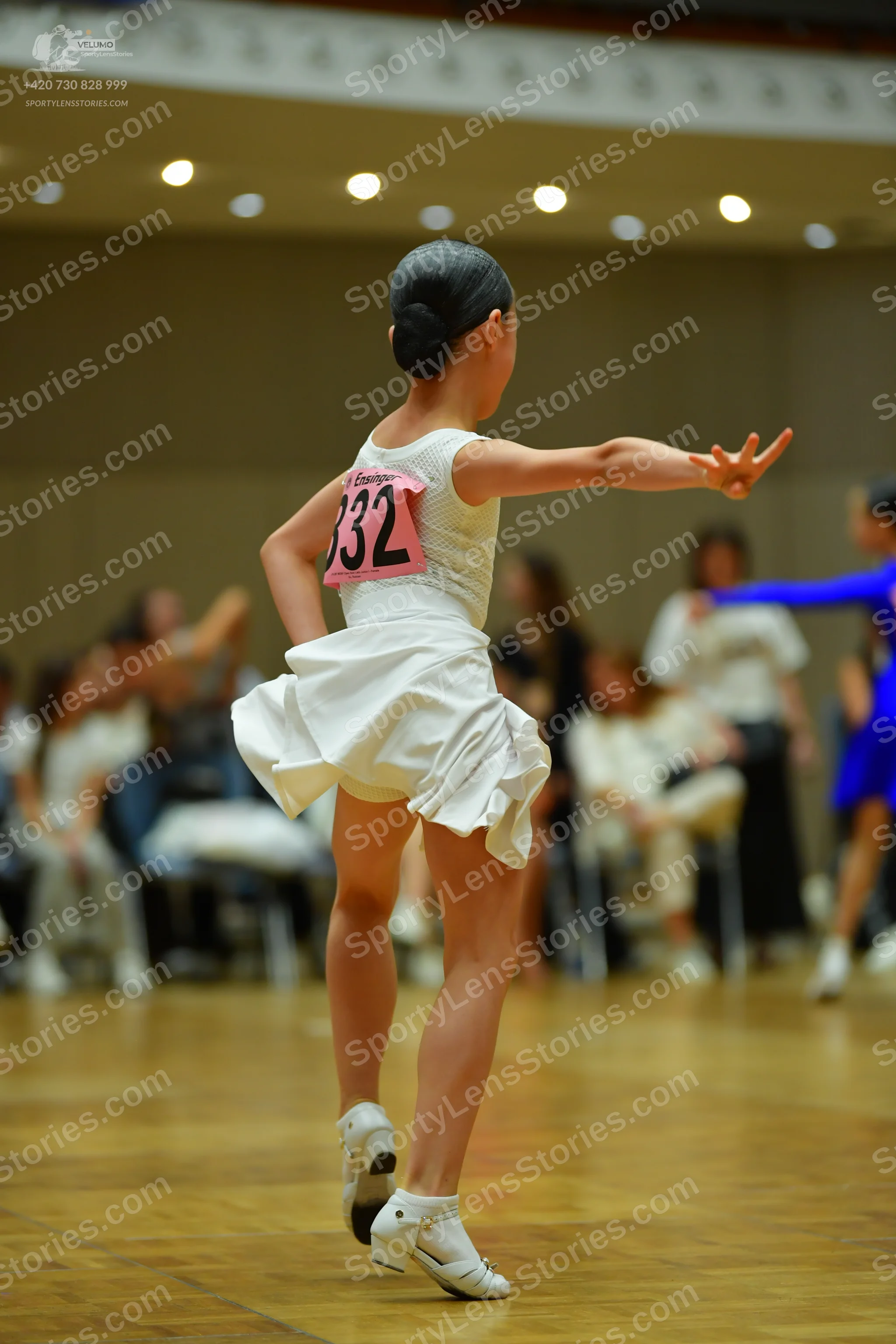 Dancesport competitor #832: Female dancer: white sleeveless dress with a ruffled skirt and white dance shoes