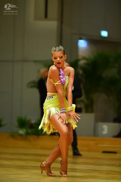 Dancesport competitor: Female dancer: yellow latin dress with fringe