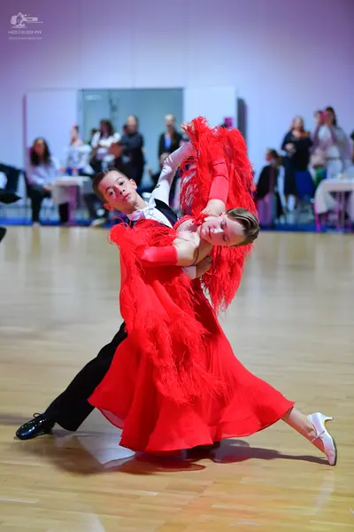 Dancesport competitor: Male dancer: black suit, white shirt, white bow tie, and black trousers