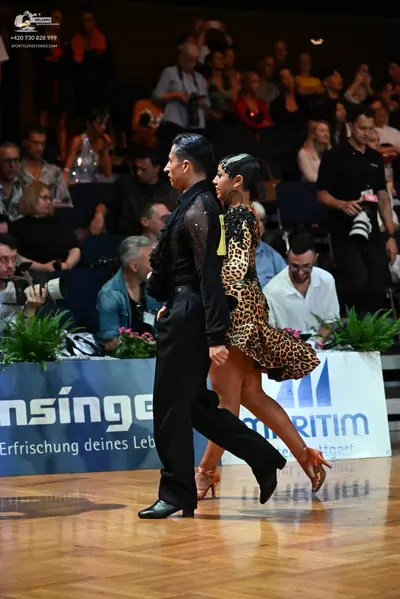 Dancesport competitor: Male dancer: black long-sleeved shirt with mesh detailing on the sleeve and blac