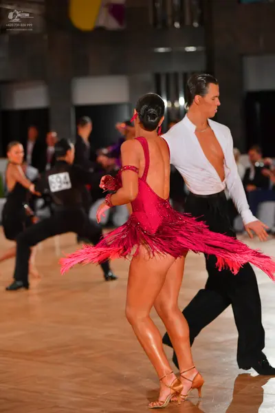 Dancesport competitor #694: Female dancer: red latin dress with sequins and fringe