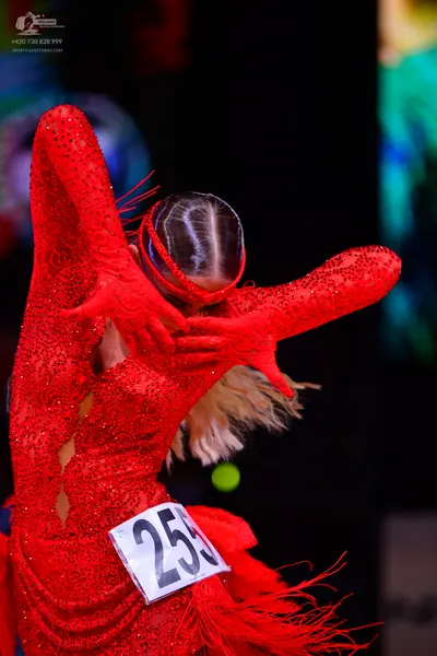 Dancesport competitor: Female dancer: red latin dress with sequins and fringe