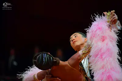 Dancesport competitor: Male dancer: dark suit with some light-colored/sequined detail on the shoulder