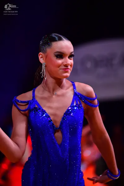 Dancesport competitor: Female dancer: blue sequin latin dress with thin straps