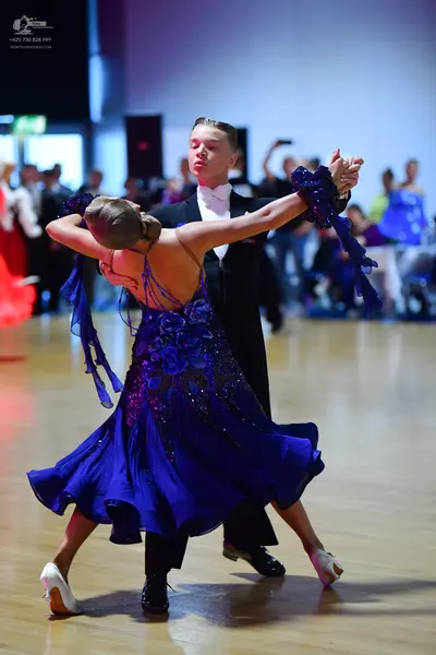 Dancesport competitor: Male dancer: black suit with a white shirt and white bow tie
