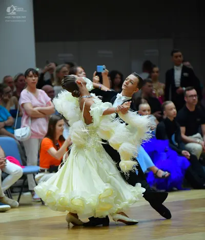Dancesport competitor: Male dancer: black ballroom suit with a white shirt and white bowtie