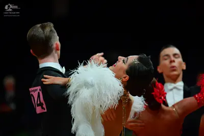 Dancesport competitor: Male dancer: black suit, white shirt, and white bow tie