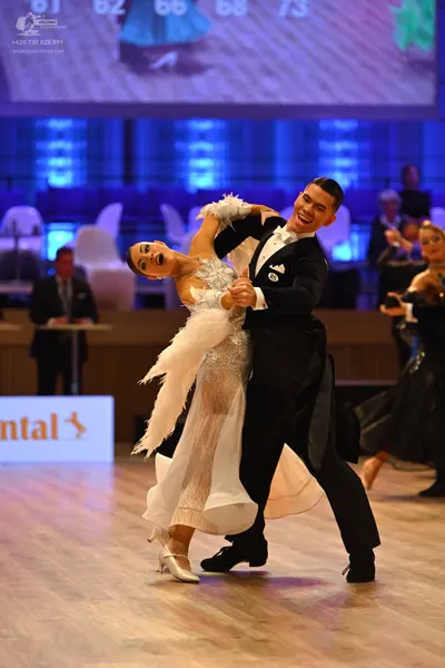Dancesport competitor: Male dancer: black suit, white shirt, and black bowtie