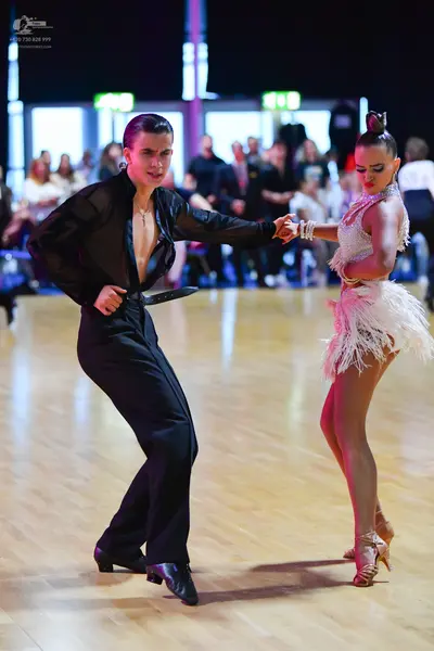 Dancesport competitor: Male dancer: black long-sleeved shirt and black trousers