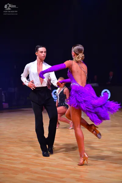 Dancesport competitor: Male dancer: white long-sleeved shirt and black trousers