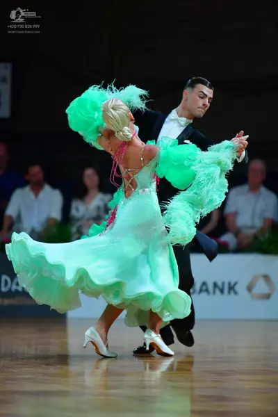 Dancesport competitor: Male dancer: black suit with a white shirt