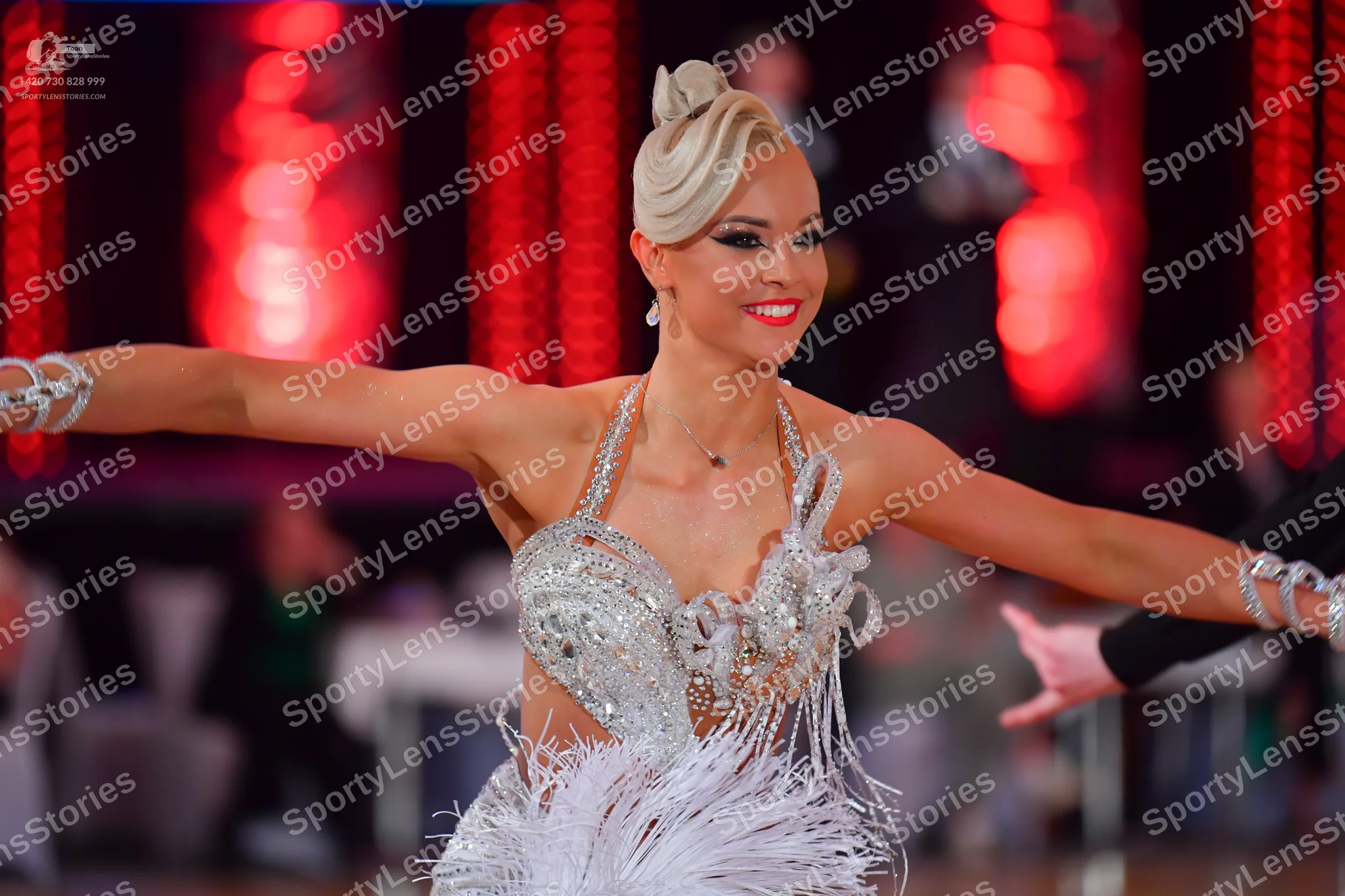 Dancesport competitor: Female dancer: white Latin dance costume with heavy silver sequin and crystal em