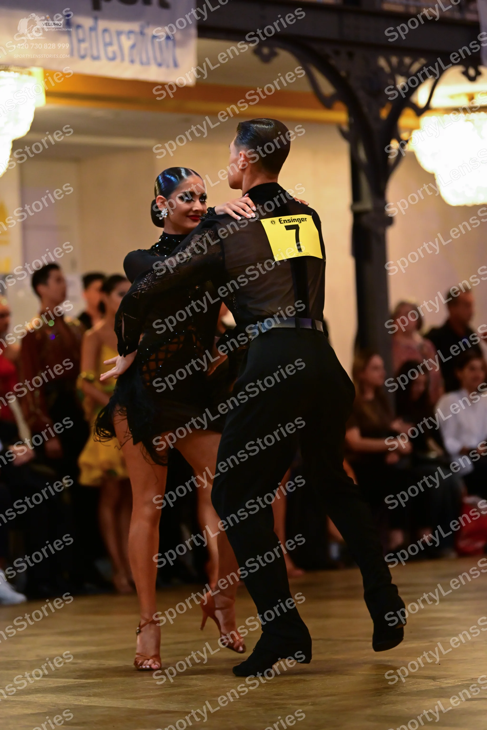 Dancesport competitor: Male dancer: black shirt with sheer/mesh panels and black trousers