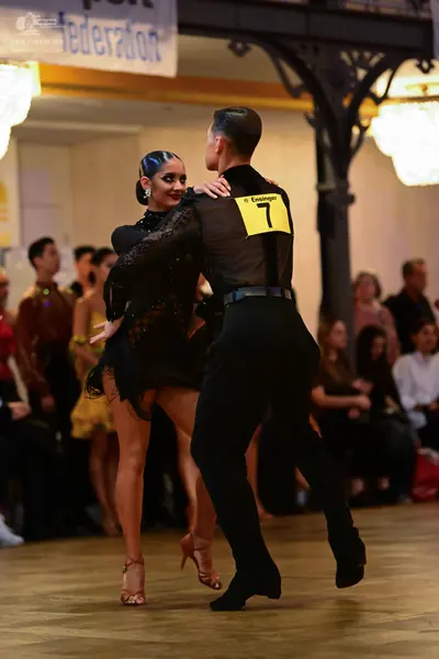 Dancesport competitor: Male dancer: black shirt with sheer/mesh panels and black trousers