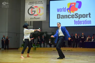 Dancesport competitor: Female dancer: white long-sleeved blouse and black leggings