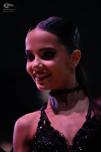 Dancesport competitor: Female dancer: black dance dress with sequins/embellishments and a black choker