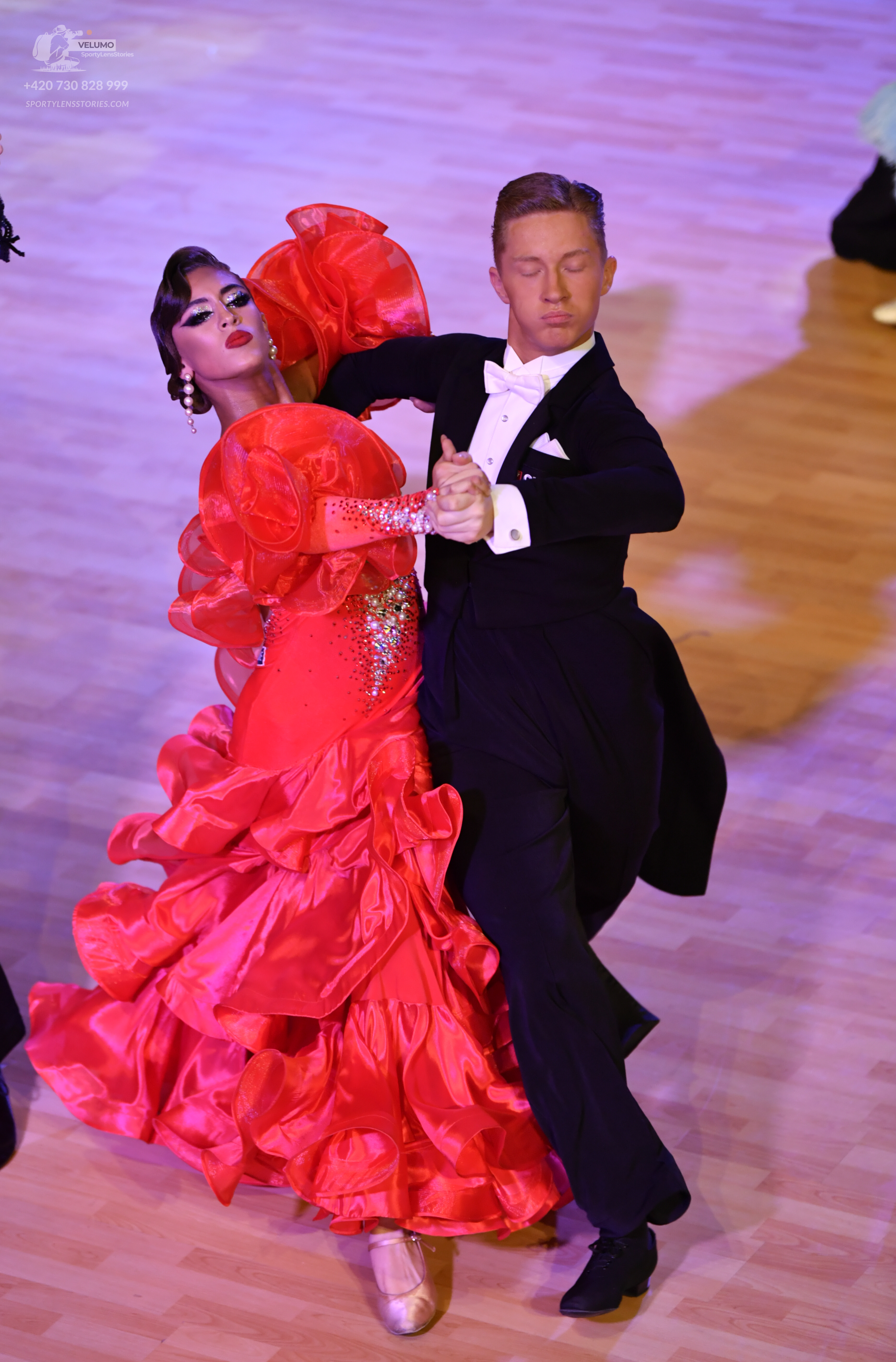 Dancesport competitor: ** Red Latin dress
*   **Color:** Bright Red
*   **Fabric:** Appears to be satin